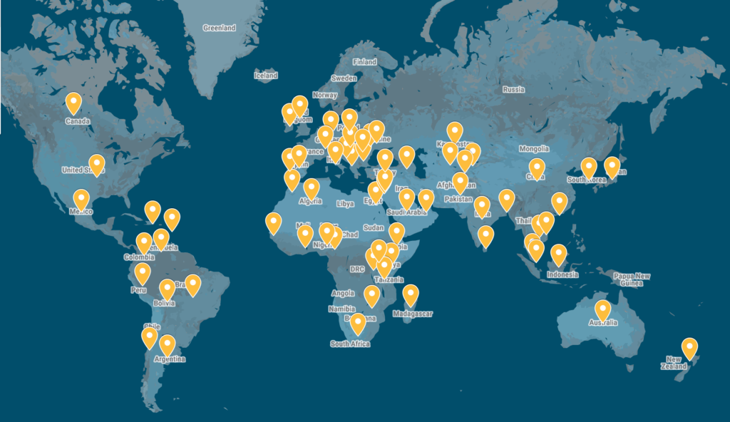 A dark blue world map with yellow markers in 60+ countries indicating places where teams submitted to Technovation Girls
